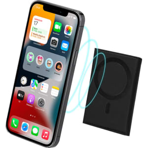 A black Enkor Card Holder beside a smartphone displaying apps, featuring a circular wireless charging area.