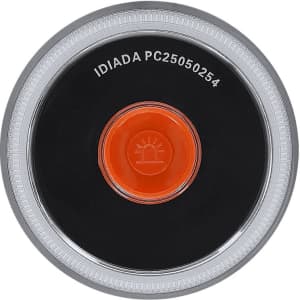 A round emergency light in black and silver, featuring a central orange button and a logo on the surface.