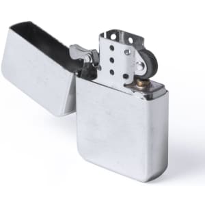 A silver lighter with a flip-top design, featuring a hinge and a spark wheel. It has a simple, sleek appearance.