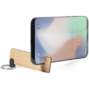 A wooden keyring phone stand, featuring a minimalist design, showcases a smartphone upright for easy viewing.
