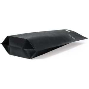 A black tote bag with a structured design and a branding logo on the side. The bag is open at the top.