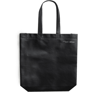 A black tote bag with two handles, featuring a logo and a flat bottom for stability.