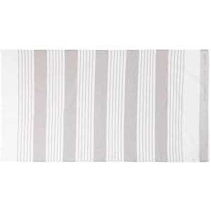 A striped bath towel in white and light grey, featuring a subtle logo on one edge.