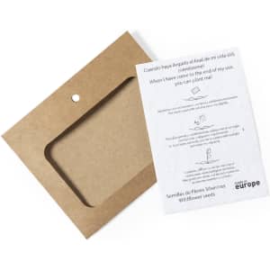 A brown cardboard packaging with a clear window and an informational card about wildflower seeds.