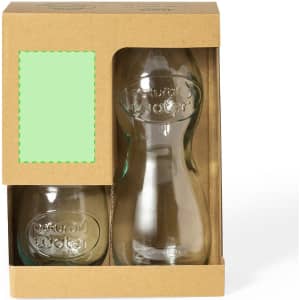 A glass drink bottle and a matching glass, both clear, packaged in a cardboard box with a logo.