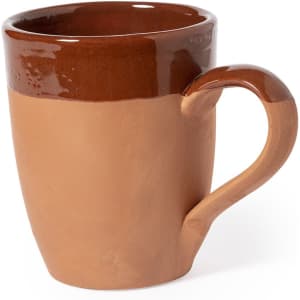 A coffee mug featuring a two-tone design in brown and terracotta, with a curved handle and a glossy finish.