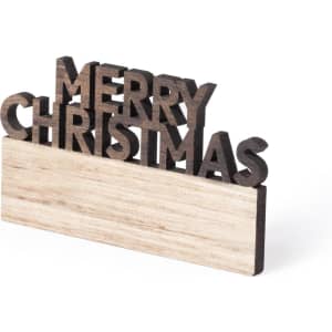 A wooden Christmas decoration featuring the words “MERRY CHRISTMAS” in a dark finish on a light base.