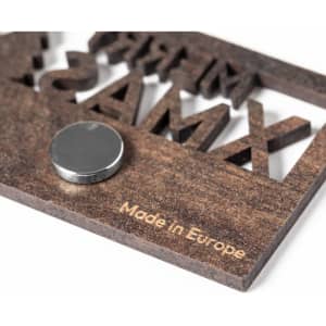 A wooden magnet with a metallic disc, showcasing a unique design and the words "Made in Europe."