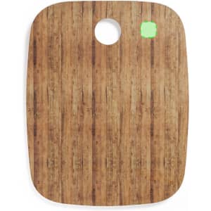 A chopping board with a wooden pattern, featuring a circular hole and a small green highlight.