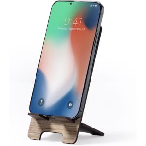 A photo frame holder in wood and black, designed to support a smartphone in an upright position.