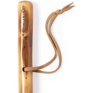 A wooden walking pole with a natural finish and a braided strap for secure handling. It features a branding logo.