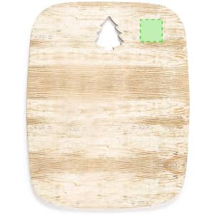 A wooden cutting board featuring a tree-shaped cutout at the top, with a rustic, light brown finish.