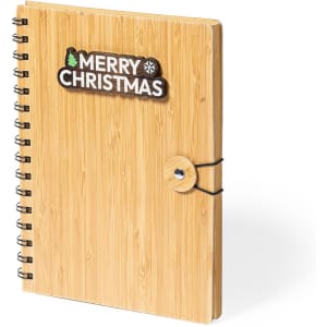 A bamboo notebook with a spiral binding and a decorative logo on the cover, featuring a Christmas theme.
