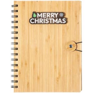 A bamboo notebook with a spiral binding and a circular fastener, featuring a logo on the cover.
