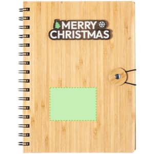 A bamboo-covered notebook with a green insert and a spiral binding. It features a festive logo.