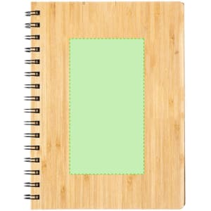 A natural bamboo notebook with a green accent panel and spiral binding, featuring a logo on the cover.