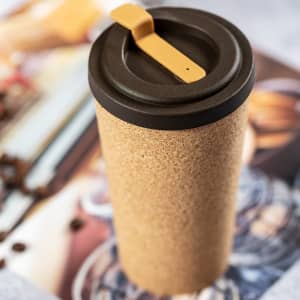 A drink bottle featuring a cork body and a black lid with a yellow lever. It has a logo on the side.