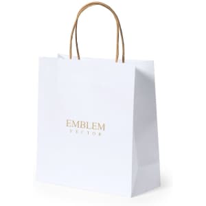A white paper bag with a logo and tan handles, designed for carrying items.