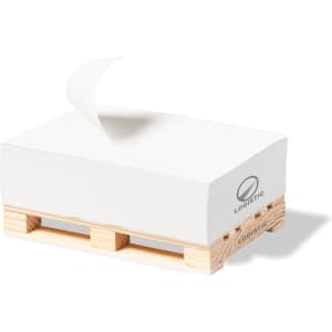 A white notepad on a wooden pallet, featuring an unspecified logo. The notepad has a single sheet slightly curled at the top.