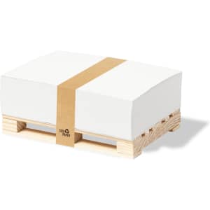 A stack of white notepads wrapped with a brown band, placed on a wooden pallet.