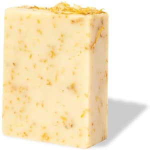 A bar of Gopax Soap in cream colour with embedded yellow floral pieces and a smooth surface, featuring a logo.