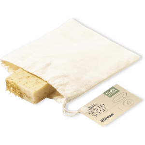 A solid bar of yellow soap in a reusable fabric pouch, featuring a tag with product information.