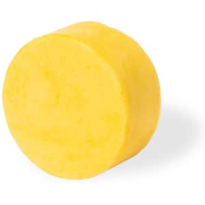 A circular yellow shampoo bar with a smooth surface, suitable for hair care. It features a logo on its packaging.
