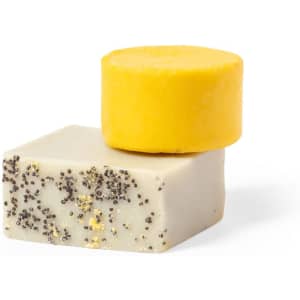 A yellow solid bar stacked on top of a white bar with black specks, showcasing a natural and raw appearance.