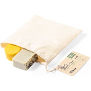 A fabric pouch containing two solid shampoo soaps, one yellow and one grey with poppy seeds. The pouch has a logo.
