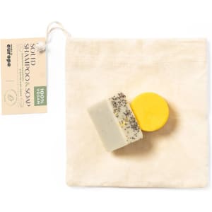 A solid shampoo bar and soap in yellow and cream, packaged in a natural canvas bag with a logo.