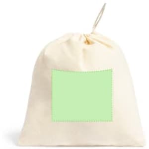 A drawstring bag in cream with a plain green patch for custom branding. It has a simple, versatile design.