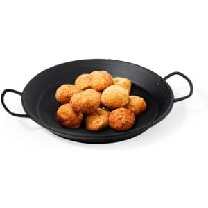 A black serving plate holds a pile of golden-brown, crispy croquettes.