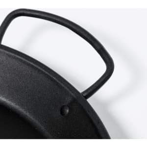 A black cast iron plate with a sturdy handle, featuring a matte finish and textured surface.