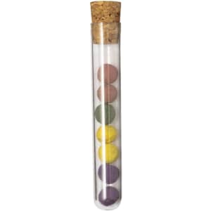 A test tube filled with colourful chocolate bonbons in various shades including purple, yellow, green, and pink, sealed with a cork.