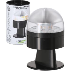 A geolocated emergency light in black with a transparent dome, displayed alongside its packaging.