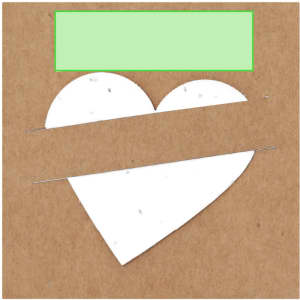 A brown paper packet with a white heart shape cut-out, featuring a green label at the top.