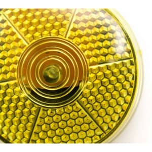 A round, yellow promotional security light with a textured honeycomb design and a central button.