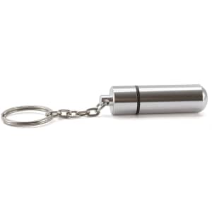 A silver pillbox keyring with a cylindrical design and a keychain attachment. The product has a metal finish.