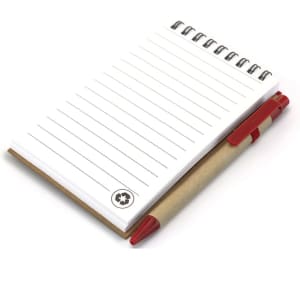 A spiral-bound notebook with lined pages and a red pen, featuring a branding logo. The notebook has a brown cover.