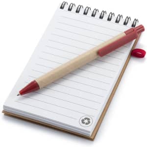 A small, spiral-bound notebook with blank pages and a red pen resting on top. The notebook has a recycled logo.