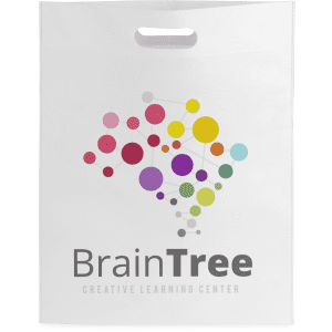 A white promotional bag featuring a colourful design and a logo for a creative learning centre.