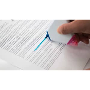 A highlighter in a person's hand marking text on a sheet of paper, featuring a pink and blue design.