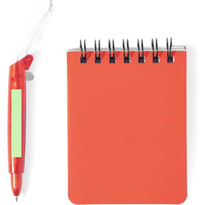 An orange mini notebook with a spiral binding and a red pen beside it, featuring a clear grip area.
