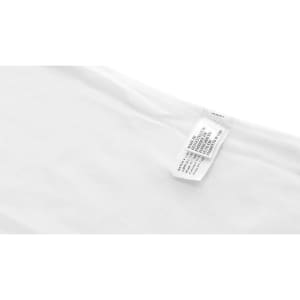 A white polo shirt with fabric care tags visible. The shirt is categorized under women's polo shirts.