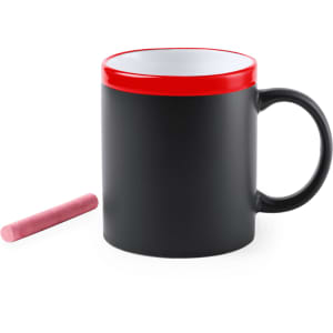 A black mug with a red rim and a pink chalk stick beside it. The mug has a handle and a glossy finish.