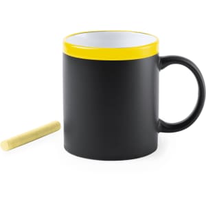 A black coffee mug with a yellow rim and a piece of chalk beside it. The mug features a logo.
