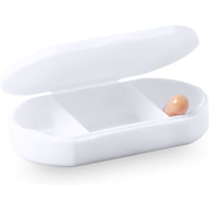 A white pillbox with a hinged lid, featuring two compartments and one orange pill inside.