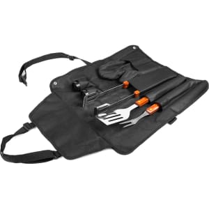 A black barbecue set featuring utensils including a spatula, fork, and tongs, neatly stored in a carrying case.