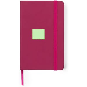 A pink notepad with an elastic band and a small green label on the front.