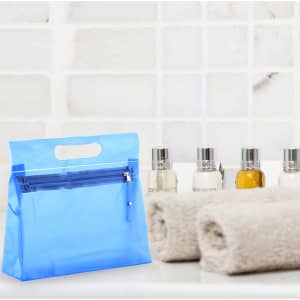 A blue toiletry bag with a front zipper pocket, accompanied by small bottles and rolled towels.